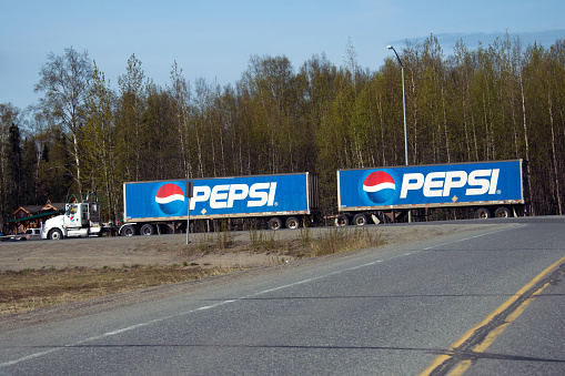 Talkeetna, AK, USA - May 12, 2015: A tractor pulling dual Pepsi trailers travels along the George Parks Highway on May 12, 2015 near Talkeetna, Alaska.