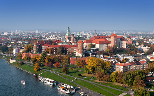 Panorama of Cracow, Poland, with royal Wawel castle and Vistula river in autumn. Aerial view at sunset.