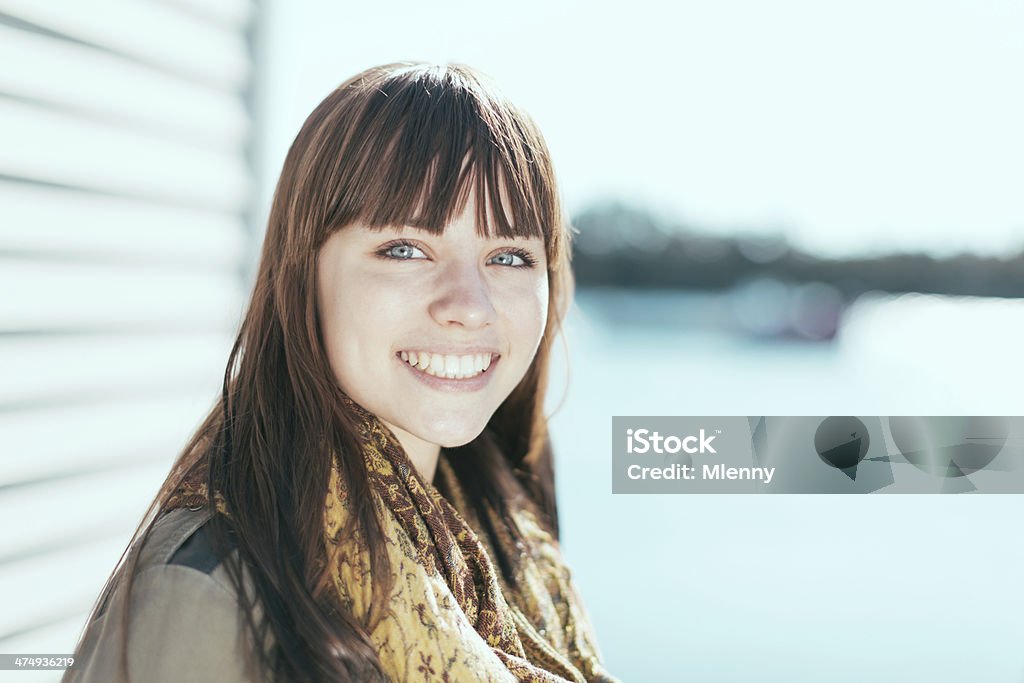 Happy smiling beautiful girl at the lake Happy smiling beautful girl with stunning blue eyes on a sunny day at the lake. Natural sunny autumn light Portrait. Nova Scotia, Canada. Adult Stock Photo