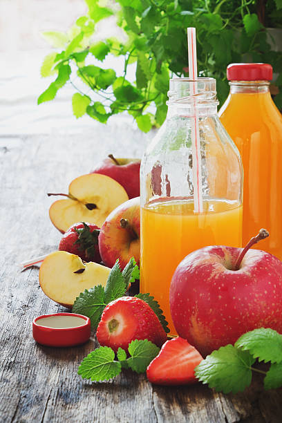 istock fruit juice, ripe apples and strawberries 474937972