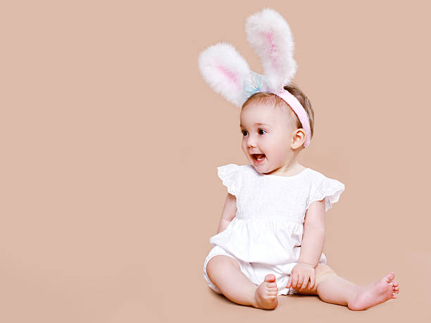 istock Cute baby sitting in costume easter bunny 474939310