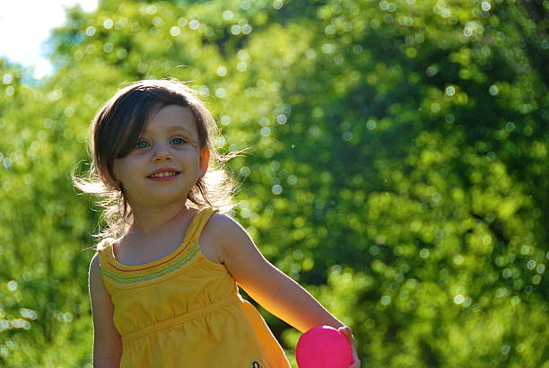 Happy girl with a pink ball stock photo