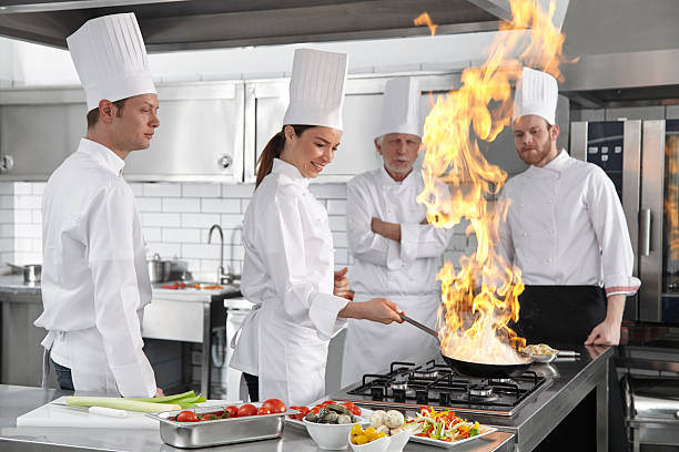 istock Female chef Cooking oyster in framing pan. 474940360
