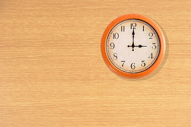 istock Clock showing 3 o'clock on a wooden wall 474940946