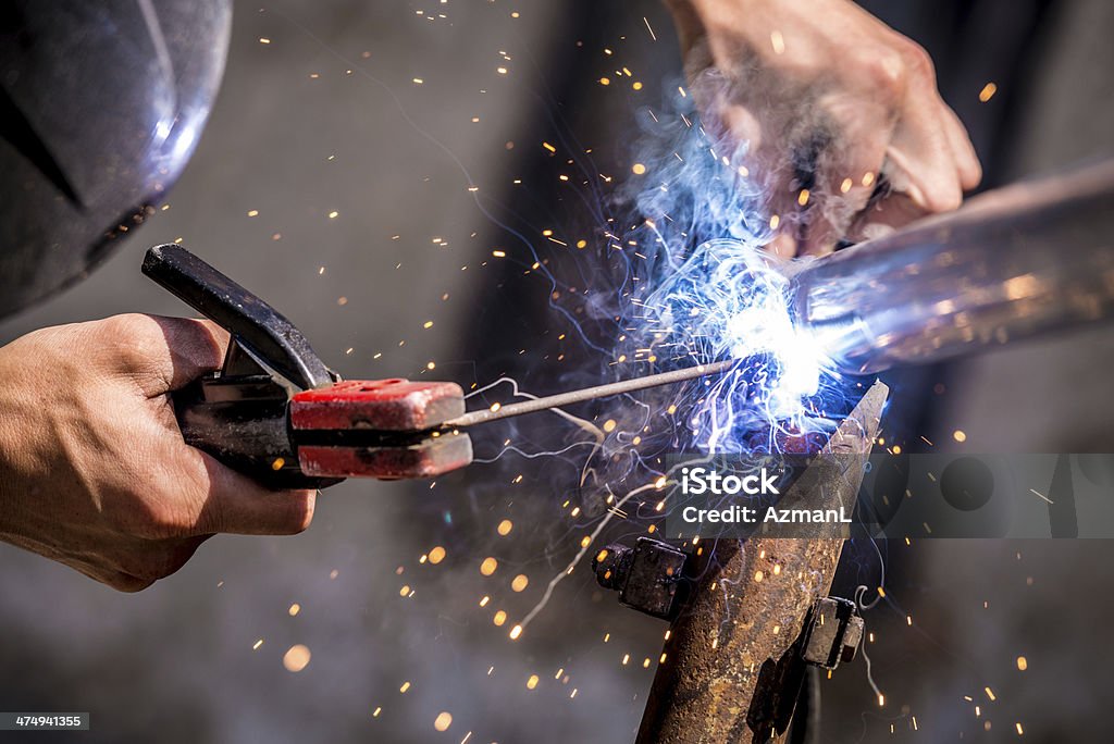 Welder at work Metal worker / welder welding metal. Activity Stock Photo