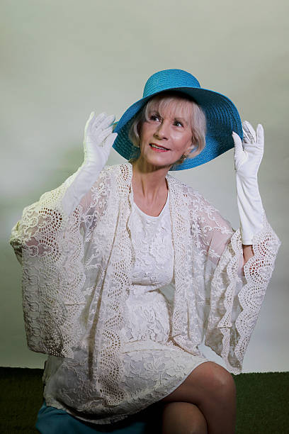 istock Senior Adjult Holding Her Hat By The Brim 474941440