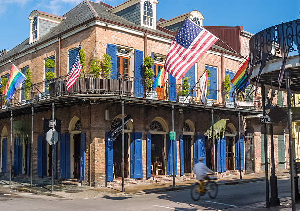 New Orleans, LA, USA - June 29, 2022: View of Bourbon Street at sunrise, without the daily activity of tourists who frequent this area for parties and fun. In the background, in the image we can see the Saint Louis Cathedral. Bourbon Street is the hub of nightlife in the French Quarter of New Orleans.