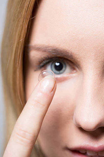 istock Putting on contact lens 474943602