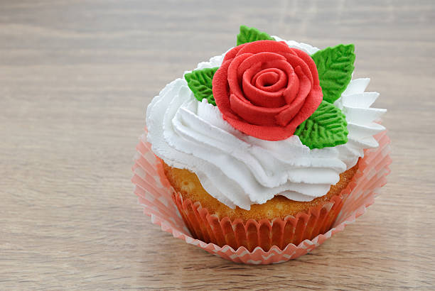 Muffin with butter cream decorated   red sugar rose