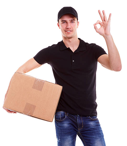 istock Delivery man holding a cardboard box 474946432