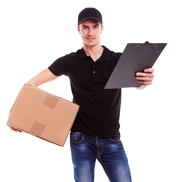 istock Delivery man holding a cardboard box 474946434