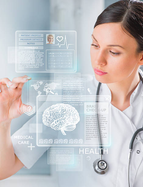 Calm doctor touching a medical interface in the hospital stock photo