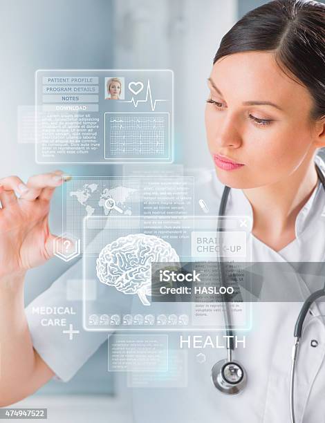Calm Doctor Touching A Medical Interface In The Hospital Stock Photo - Download Image Now