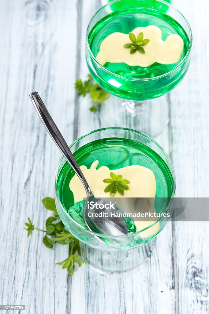 Portion of Woodruff Jelly with Vanilla Sauce Portion of Woodruff Jelly with Vanilla Sauce on bright wooden background 2015 Stock Photo