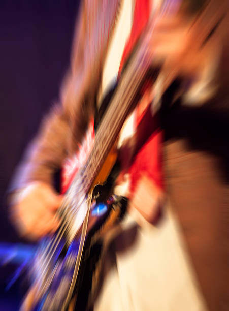 istock man playing rock guitar on concert,blurred rock background 474948158