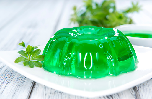 Homemade Woodruff Jello (on a bright wooden background)