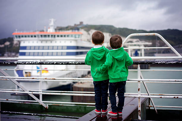 istock Two smiling little boys on deck of ferry 474950346