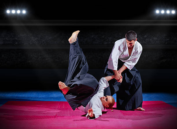 istock Fight between martial arts fighters at sports hall 474952162