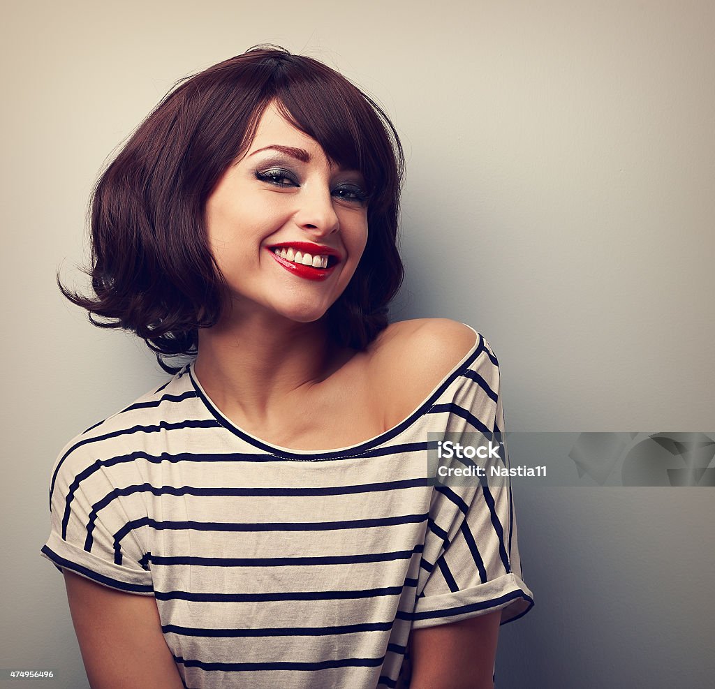 Happy laughing young woman with short hair in fashion blouse Happy laughing young woman with short hair in fashion blouse. Vintage closeup portrait Hairstyle Stock Photo