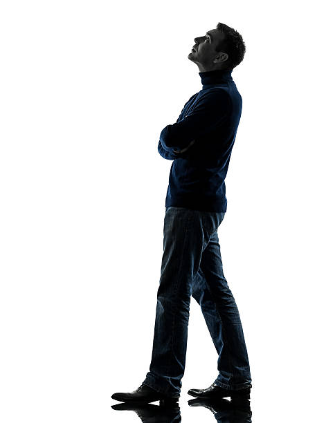 istock man looking up pensive silhouette full length 474957889