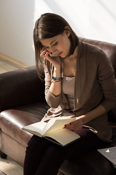 istock Business woman talking mobile phone and holding notepad 474958368