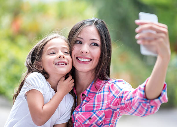 istock Mother and daughter taking a selfie 474961930