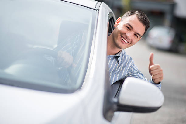 istock Man driving a car with thumbs up 474962222