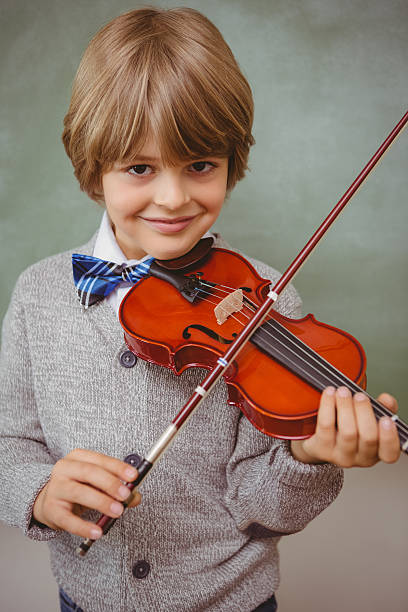 istock Portrait of cute little boy playing violin 474962980