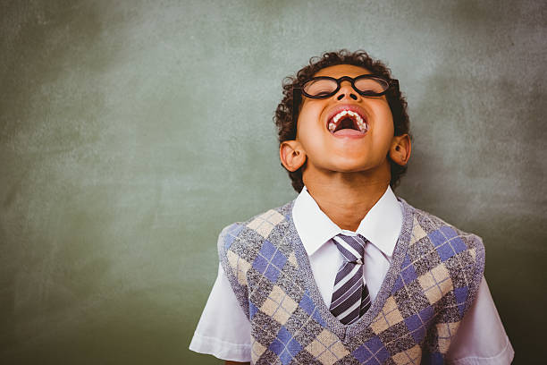 istock Boy laughing in front of blackboard 474963210