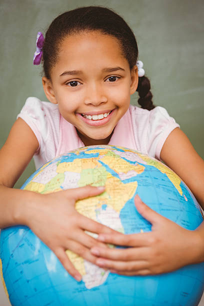 istock Cute little girl holding globe 474964222