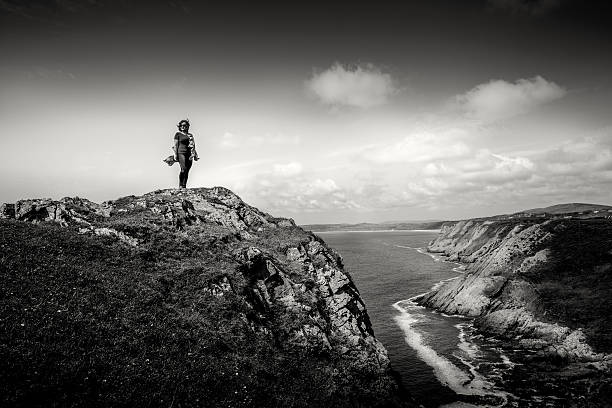 Mature hispanic woman standing on remote coastal headland
