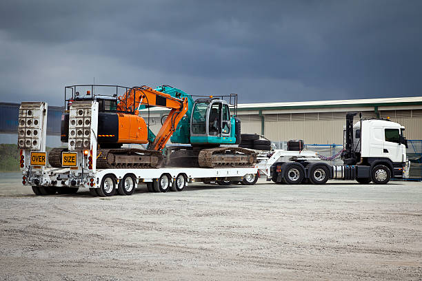 semi truck transporting construction machine