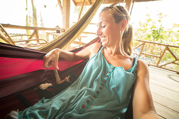 istock Girl playing with cat on hammock 474964538