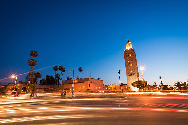 Koutoubia Mosque tower in Marrakech, Morocco at dusk with motion blurred traffic