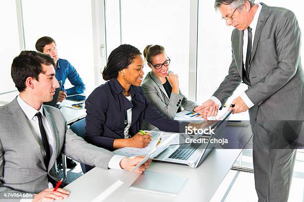 Two Business Woman Talking To Senior Manager Stock Photo - Download Image Now - 20-29 Years, 2015, 50-59 Years