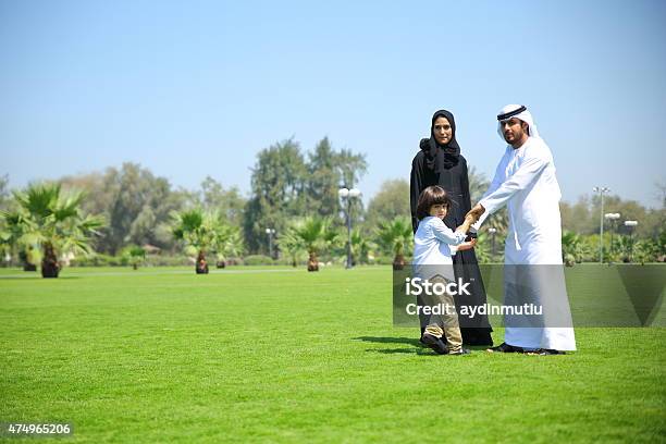 Arab Family Enjoying Their Leisure Time In Park Stock Photo - Download Image Now - 2015, Activity, Adult