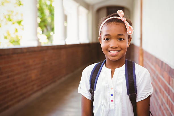 istock Little girl smiling in school corridor 474965530