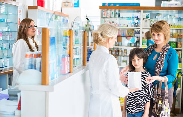 istock Pharmacist giving medication to a mother and daughter 474965766