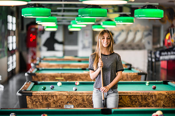 istock Happiness girl standing in a pub at the pool table 474966058