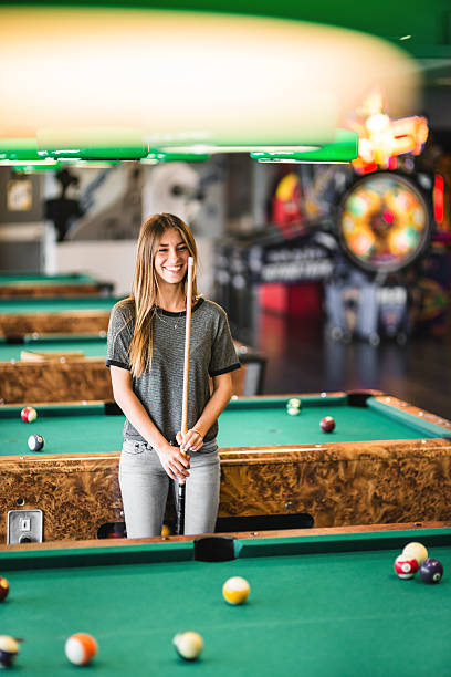 istock Happiness girl standing in a pub at the pool table 474966066