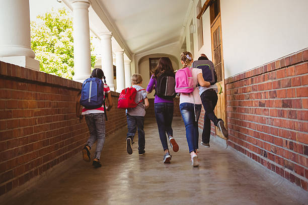 istock School kids running in school corridor 474966532