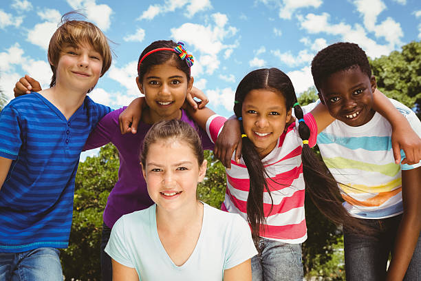 istock Happy children forming huddle at park 474966948