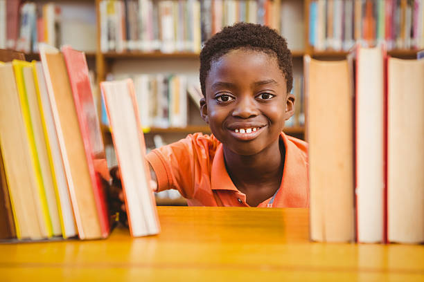 istock Portrait of cute boy in library 474967234
