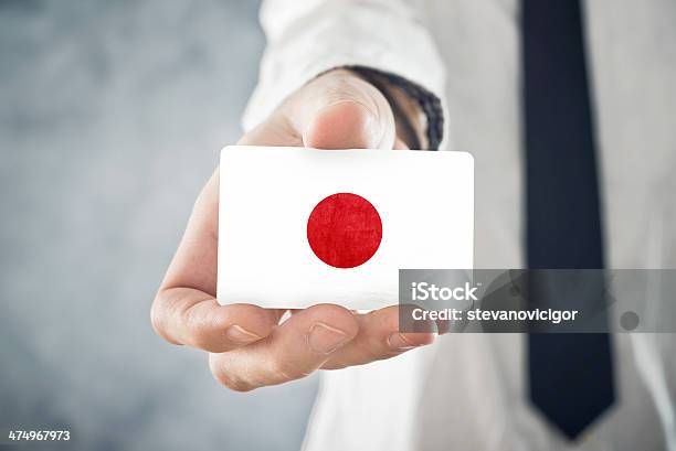 Japanese Businessman Holding Business Card With Japan Flag Stock Photo - Download Image Now