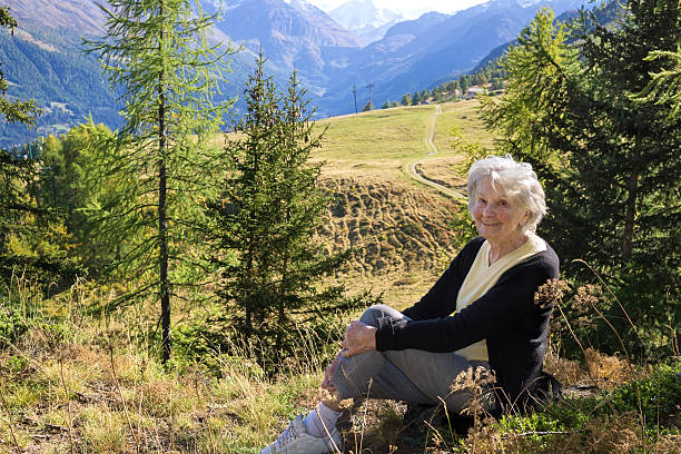 istock Elderly lady enjoying a vacation in the mountains. 474969538