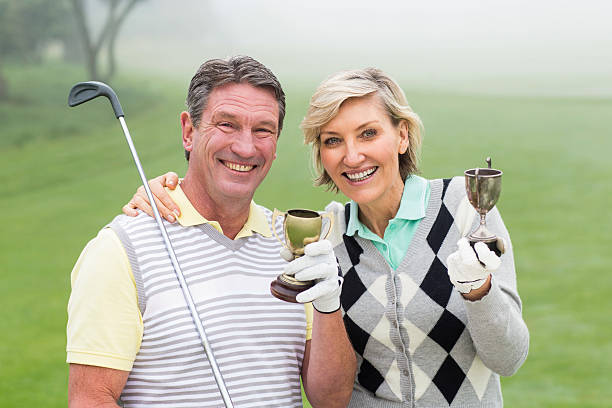 istock Happy golfing couple with trophy 474969966