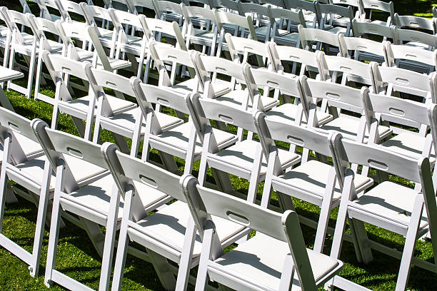 istock rows of white chairs in a garden 474971176