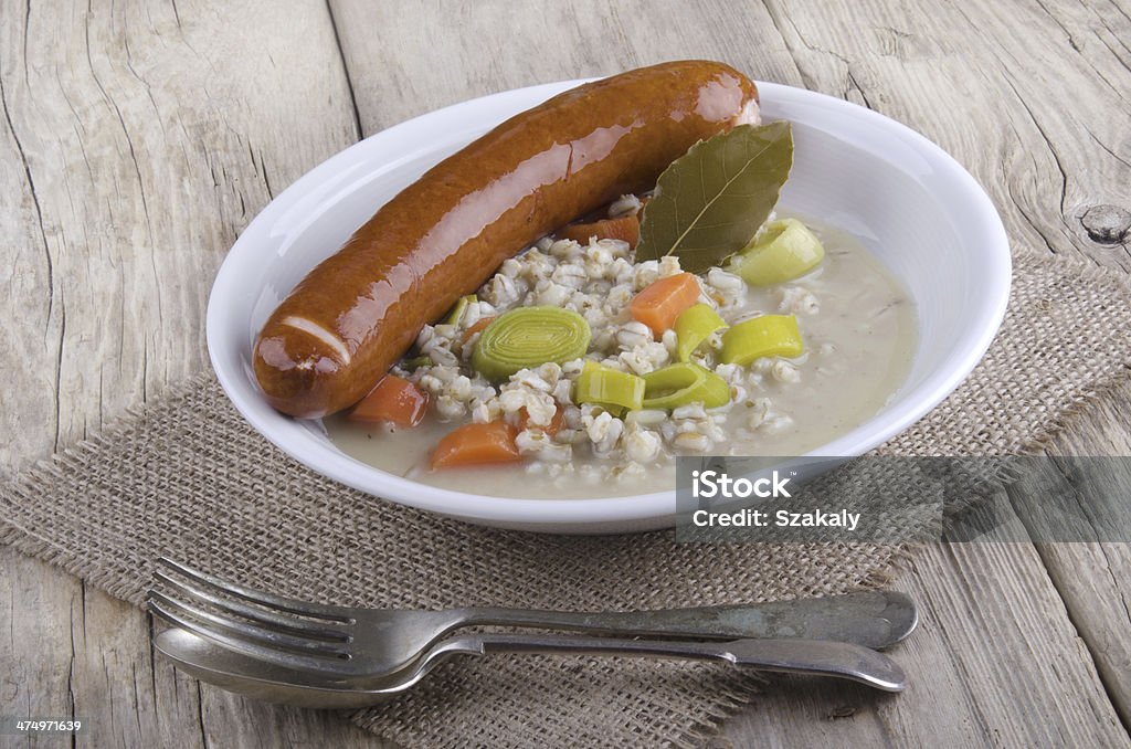 pearl barley soup with smoked sausage pearl barley soup with carrot, leek and smoked sausage Barley Stock Photo