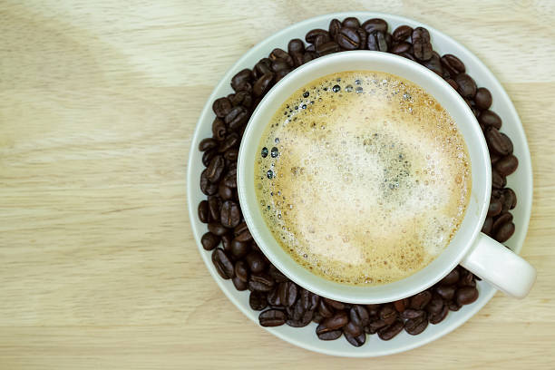 Coffee cup on wooden table. View from the top