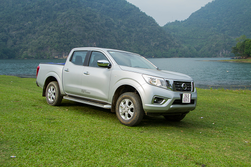 Bac Kan, Viet Nam - Apr 24, 2015: Nissan NP300 Navara car crossing glass fields in Babe lake in Vietnam